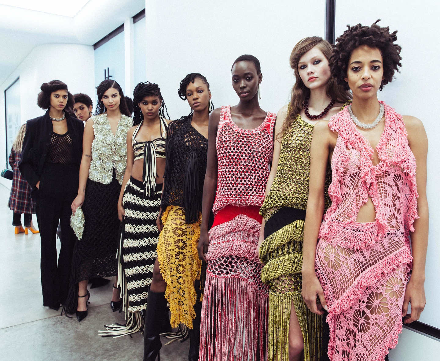 Group of models in crochet and embellished outfits backstage at NYFW F/W 2024.